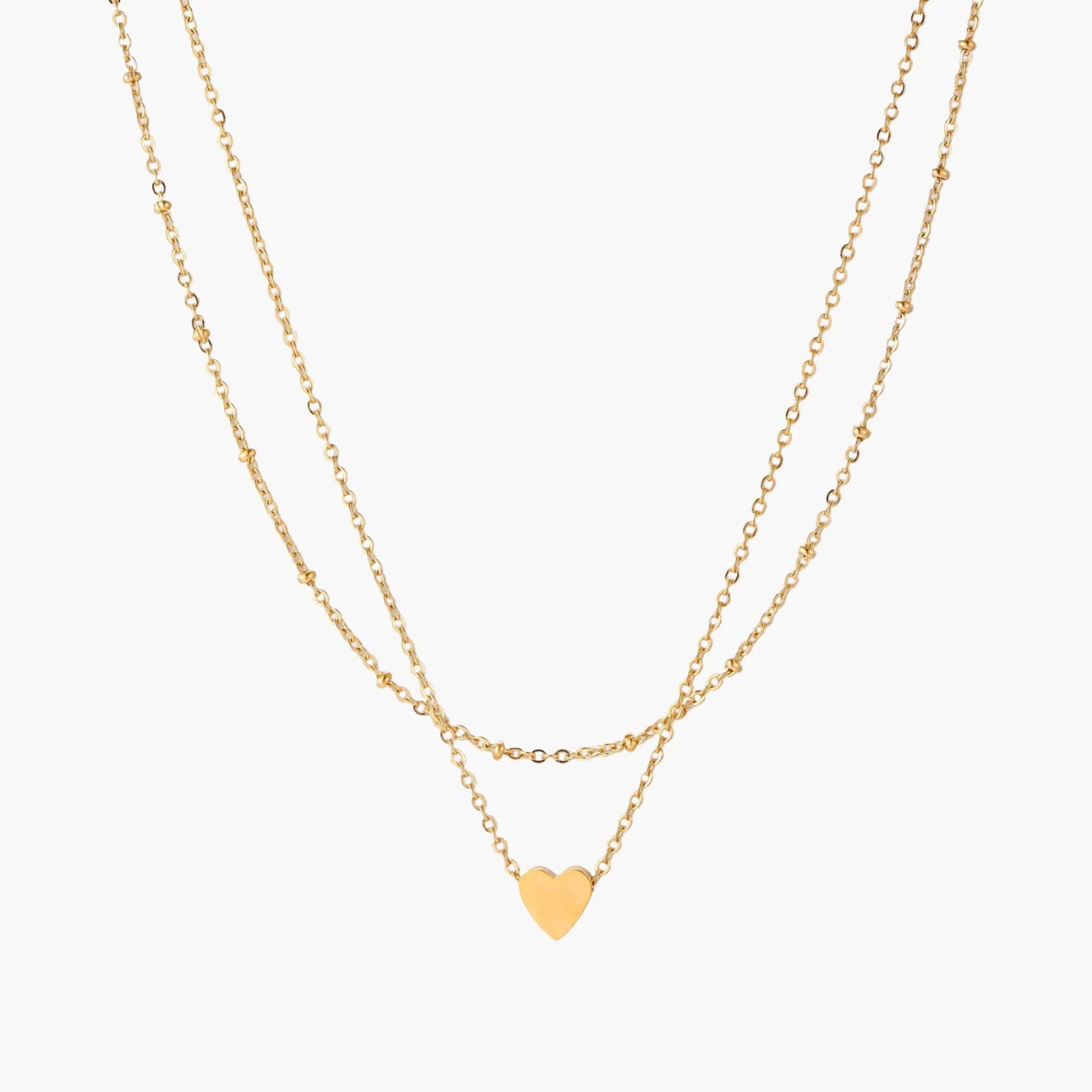 Delicate double-chain gold necklace with tiny heart pendant on cream background