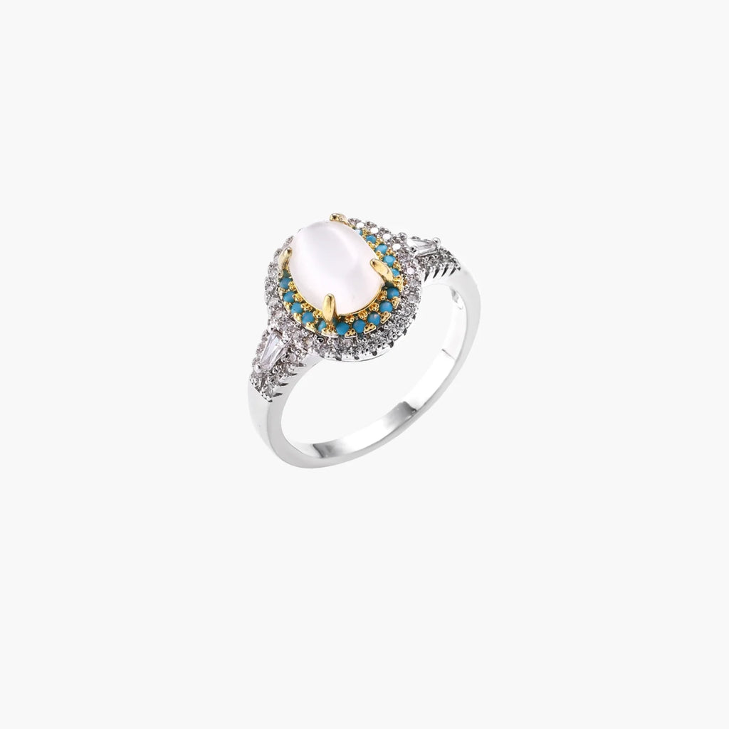 Vintage-style cocktail ring with luminous cat's eye center stone surrounded by turquoise and crystal double halo on white gold plated band